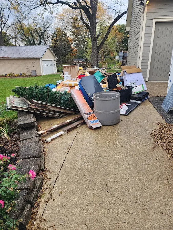 Dumpster being loaded with debris for Estate Cleanout Dumpster Rental in Edmond